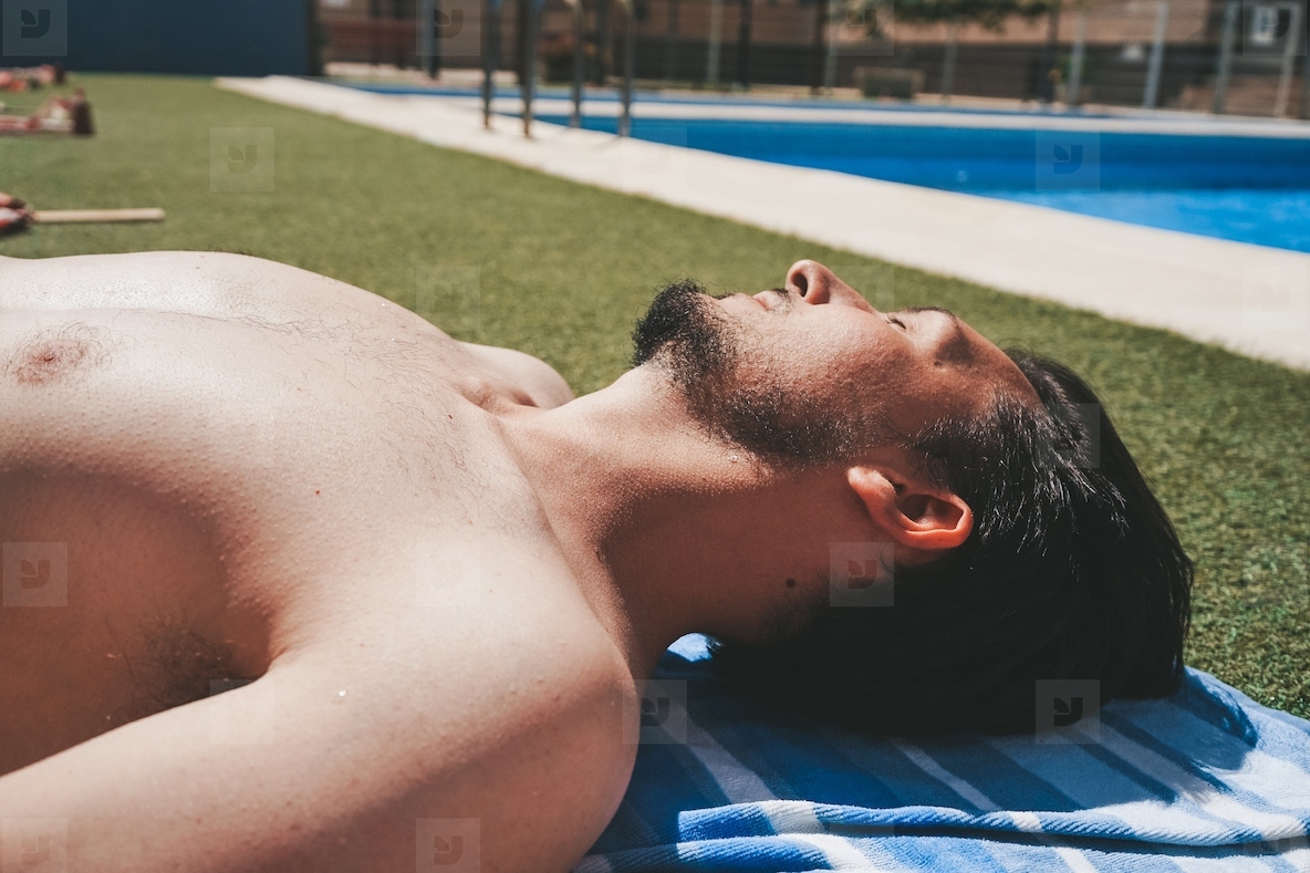Young man in a pool with restrictions of social distance