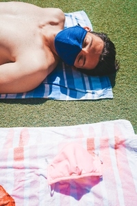 Young man in a swimming pool at summer wearing a face mask