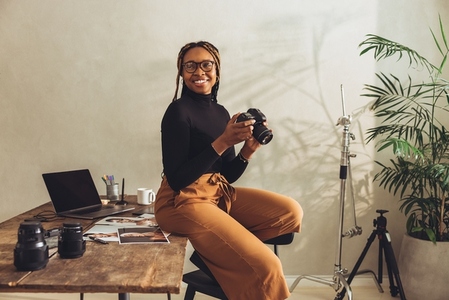 Happy female photographer smiling in her office