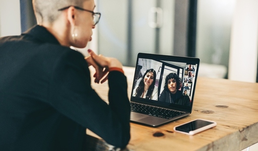 Female entrepreneur speaking during a virtual meeting in an office
