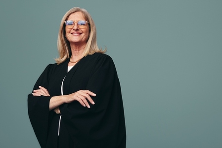 Happy female judge smiling at the camera in a studio