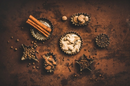 Flat lay of Turkish spice Yedi Bahar mix over rusty background