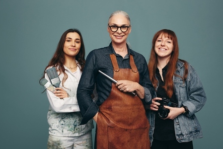 Women from different creative occupations smiling in a studio