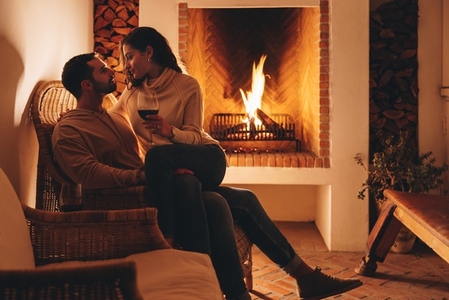 Honeymooners relaxing in front of a fireplace in a hotel