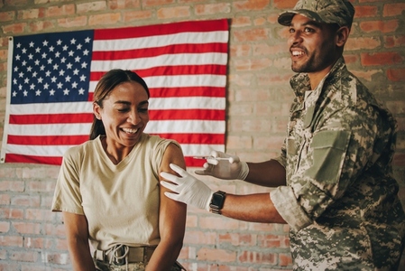 American military doctor inoculating a female soldier