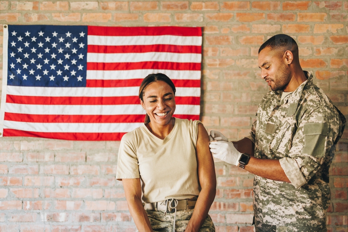 Cheerful female soldier smiling happily after vaccination