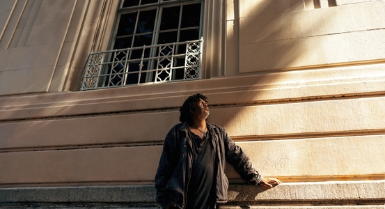 Contemplative homeless man looking up outdoors