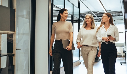 Three businesswomen walking together in an office