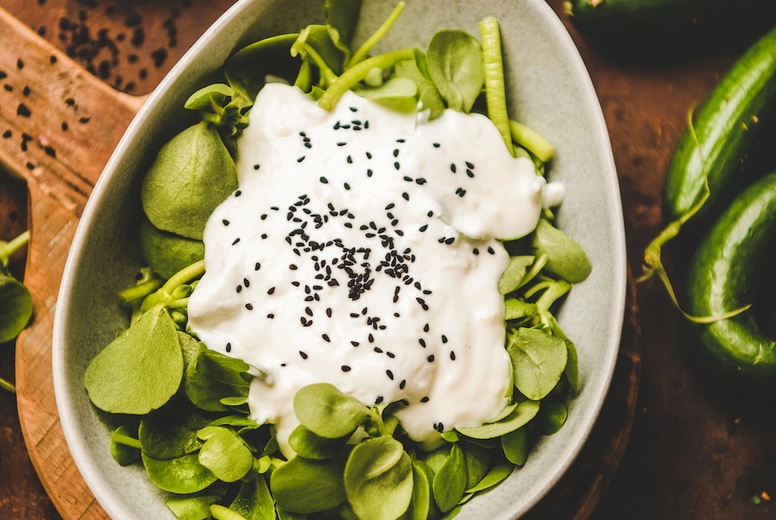 Fresh green purslane salad with yogurt, black sesame and vegetables