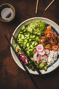Hawaiian salmon poke bowl with vegetables  greens and rice