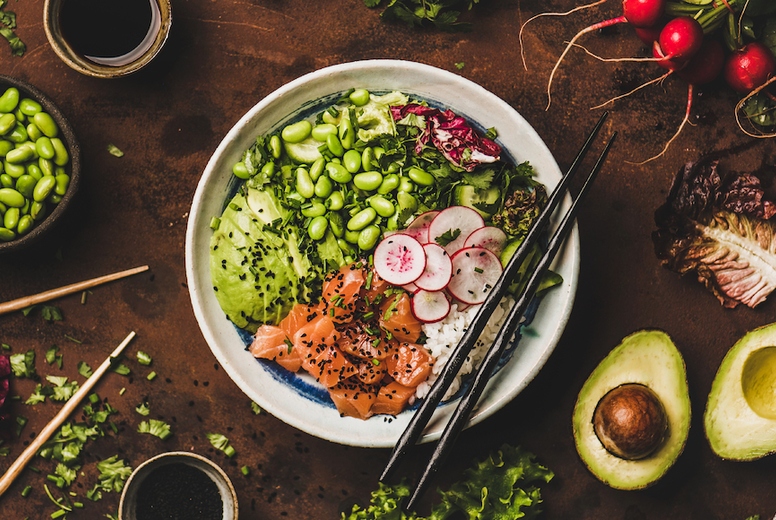 Salmon poke bowl with vegetables, greens, sushi rice, wide composition