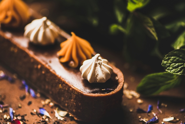 Contemporary dessert Caramel tart with Belgium chocolate and Swiss merenge