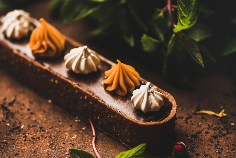 Caramel tart dessert with Belgium chocolate and Swiss merenge