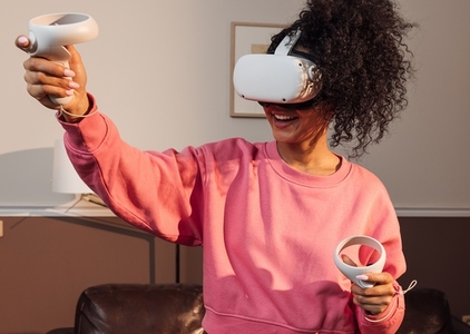 Smiling woman with VR headset having fun in the living room