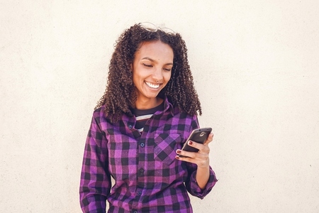 Young casual woman using her smartphone