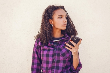 Young casual woman using her smartphone