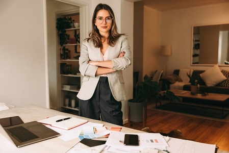 Confident interior designer standing in her home office