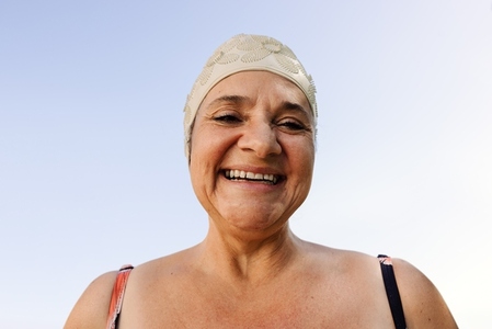 Happy senior woman smiling at the camera in swimwear
