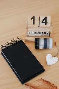 Wooden calendar on February 14 with a heart