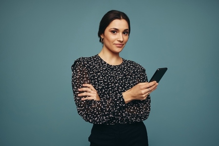 Young woman using a mobile phone in a studio