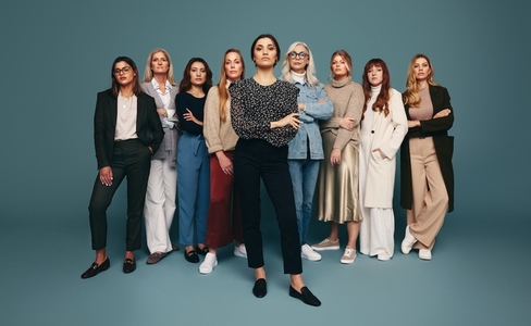 Woman standing with a group of strong and empowered women