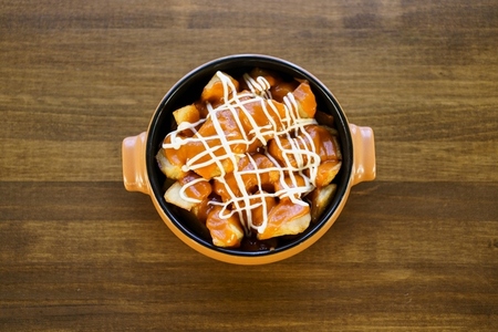 Plate of patatas bravas  a typical Spanish dish  on restaurant table