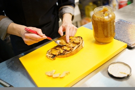 Chef putting pieces of foie on a piece of fried bread