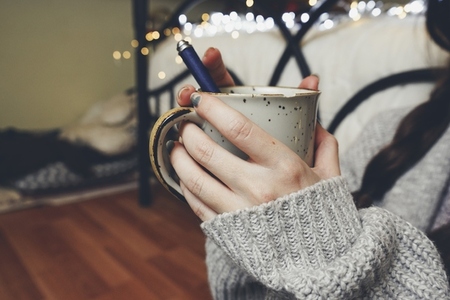 Woman hands holding a warm cup of coffee