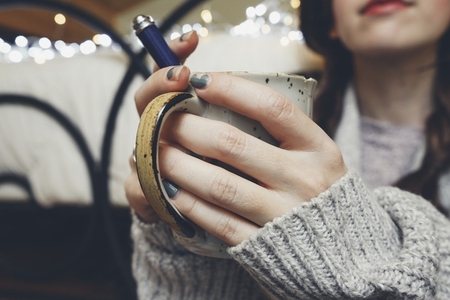 Woman hands holding a warm cup of coffee