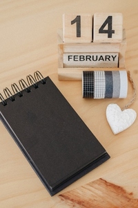 Wooden calendar on February 14 with a heart