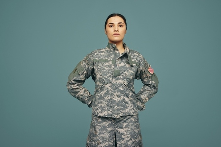 Young American army soldier standing in a studio