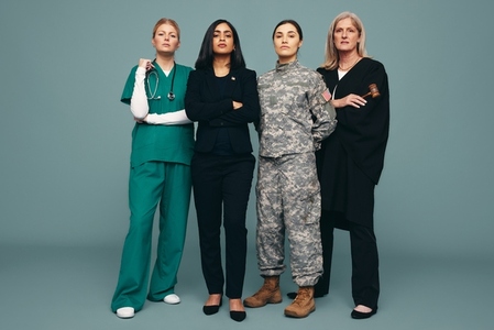 Confident women from different occupations standing in a studio