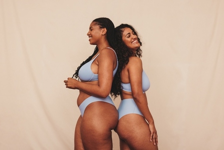 Female friends feeling comfortable in blue underwear