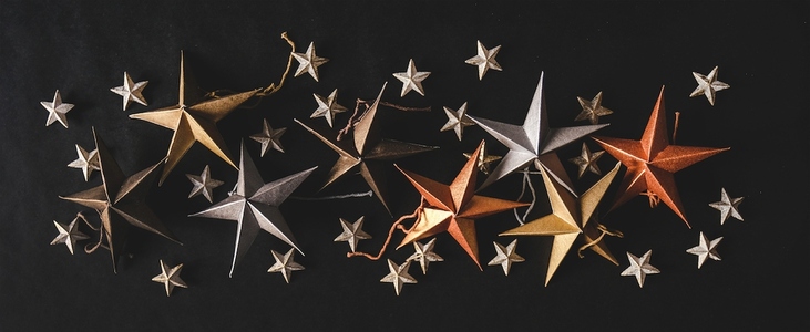Christmas decorative toy small and big stars over black background