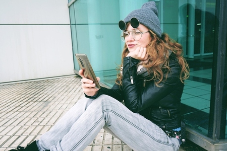 Young influencer woman using her smartphone