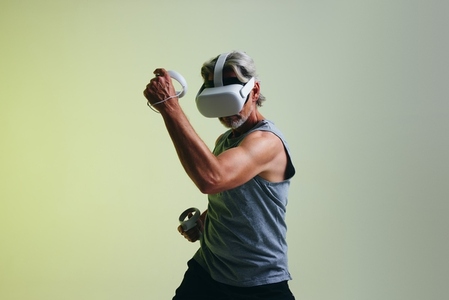 Mature man wearing a virtual reality headset in a studio