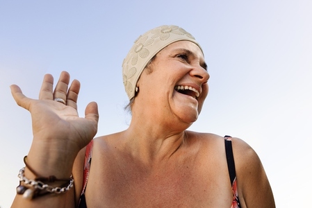 Cheerful elderly woman laughing happily in swimwear