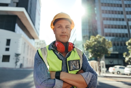 Confident construction worker looking at the camera outdoors