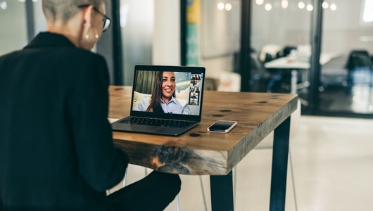 Modern businesswoman attending a video conference with her global partners
