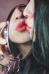 Close up of a beautiful woman reflected in a mirror