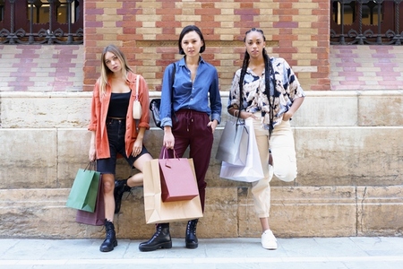 Trendy diverse women with shopping bags