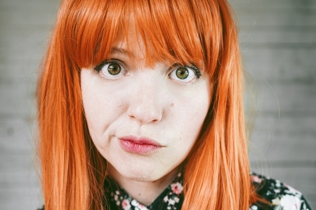 Portrait of a upset young redhead woman