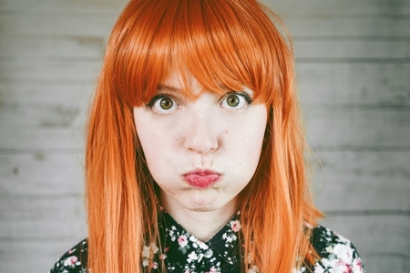 Portrait of a upset young redhead woman