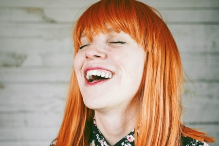 Young redhead woman with a real smile in her face