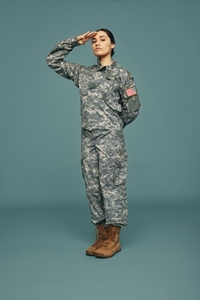 Courageous army soldier saluting in a studio