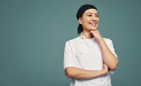 Happy culinary chef smiling cheerfully in a studio
