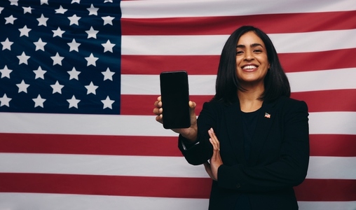 American congresswoman holding up a smartphone