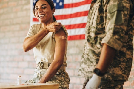 American servicewoman smiling happily after getting vaccinated