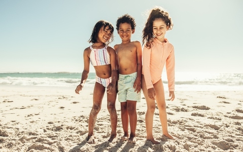 Happy young friends having a good time at the beach