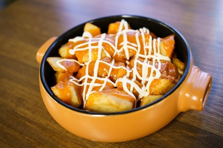 Plate of patatas bravas  a typical Spanish dish  on restaurant table